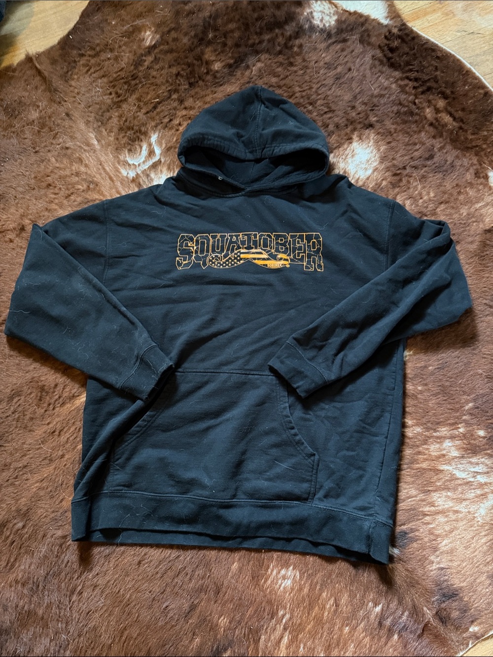 Black Hoodie with Yellow 'SQUATCHER' Chest Graphic